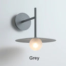 Minimalist black flying saucer wall lamp for bedroom decor
