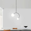 Minimalist black glass ball pendant lights – dining room curved arm