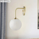 Minimalist black & gold wall light with milky glass ball for bedroom