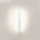 Minimalist black & white aluminum shade direct wired sconce bedroom