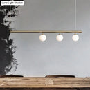 Minimalist golden glass sphere pendant light dining room