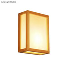 Minimalist white glass wall sconce with wooden frame for corridors
