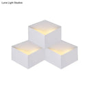 Minimalist white metallic geometric wall mount light for corridor