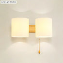 Modern beige fabric and wood wall light bedroom sconce with pull chain