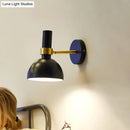 Modern black and brass domed wall lamp for bedroom bedside