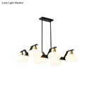 Modern black and brass linear hanging lamp with oval opal glass dining room
