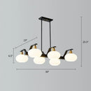 Modern black and brass linear hanging lamp with oval opal glass dining room
