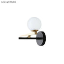 Modern black and brass wall sconce with white glass ball shade bedroom