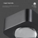 Modern black and copper bedroom wall lamp with glass dome