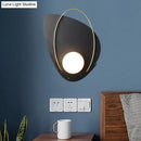 Modern black and gold wall lamp with white glass shade bedroom sconce