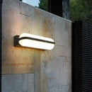 DecorBites™ Modern Black Acrylic Wall Sconce with Flush Capsule Design and Half-Bulb Mounting