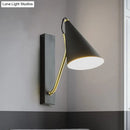 Modern black cone shade wall sconce with brass arm – bedroom light