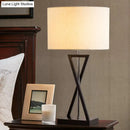 Modern black geometric nightstand lamp with cream drum shade bedroom