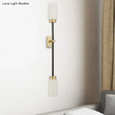 Modern black & gold wall sconce with white glass shade living room