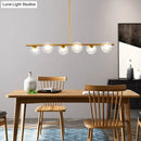 Modern black island pendant with clear glass globes dining room