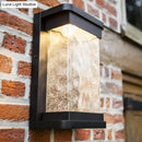Modern black led outdoor wall sconce with rippled glass cylinder