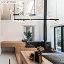 Modern black linear island pendant with glass shade dining room