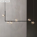 Modern black linear island pendant with glass shade dining room