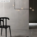 Modern black linear island pendant with glass shade dining room