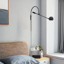 Modern black metal sphere wall sconce with curved arm bedroom light