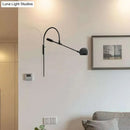 Modern black metal sphere wall sconce with curved arm bedroom light
