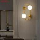 Modern black wall sconce with frosted glass globes – bedroom light