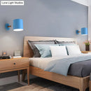 Modern blue metal tubular wall lamp with wood arm bedroom sconce light