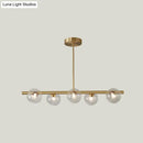 Modern brass 5-light pendant light with spherical glass shade dining room