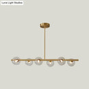 Modern brass 5-light pendant light with spherical glass shade dining room