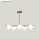 Modern brass 5-light pendant light with spherical glass shade dining room