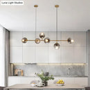 Modern brass 6-bulb island lamp with glass shade for dining rooms