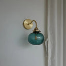 Modern brass and blue glass ball wall sconce with pull chain bedroom