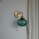 Modern brass and blue glass ball wall sconce with pull chain bedroom