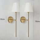 Modern brass and cream fabric led wall lamps for bedroom