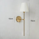 Modern brass and cream fabric led wall lamps for bedroom