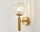 Modern brass and pink glass wall sconce for bedroom
