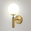 Modern brass and pink glass wall sconce for bedroom
