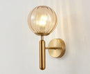 Modern brass and pink glass wall sconce for bedroom