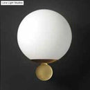 Modern brass and white glass sphere wall sconce bedroom light