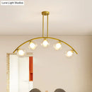 Modern brass arch arm 5-light pendant – dining room glass orb light