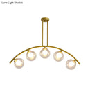 Modern brass arch arm 5-light pendant – dining room glass orb light