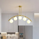 Modern brass arch arm 5-light pendant – dining room glass orb light