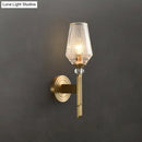 Modern brass diamond wall light with lattice glass shade bedroom