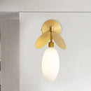 Modern brass leaf wall lamp with cream glass bedroom sconce