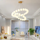 Modern brass led pendant light with frosted spheres for living room