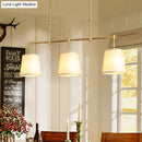 Modern brass pendant light with white green flaxen shades dining room