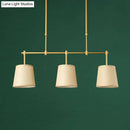 Modern brass pendant light with white green flaxen shades dining room