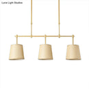 Modern brass pendant light with white green flaxen shades dining room