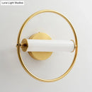 Modern brass ring wall sconce with opal glass shade bedroom light