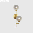 Modern brass sphere wall sconce amber & smoke gray bathroom light